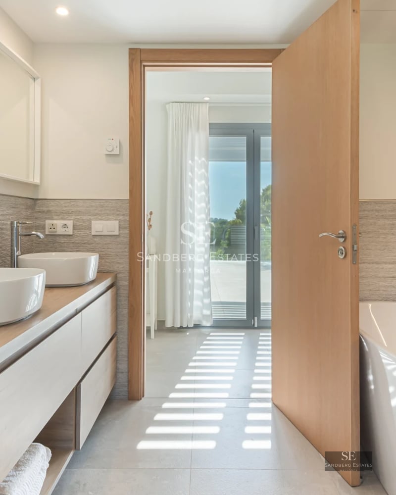 Exterior of a modern villa featuring an infinity pool, lush garden, and spacious terraces. Elegant design and high-quality finishes.