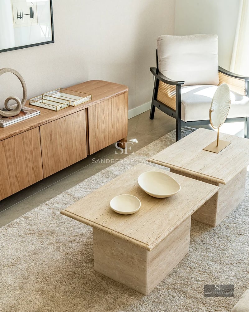 Exterior view of a modern home with a vibrant blue pool and lush garden. Minimalist architecture and large windows.