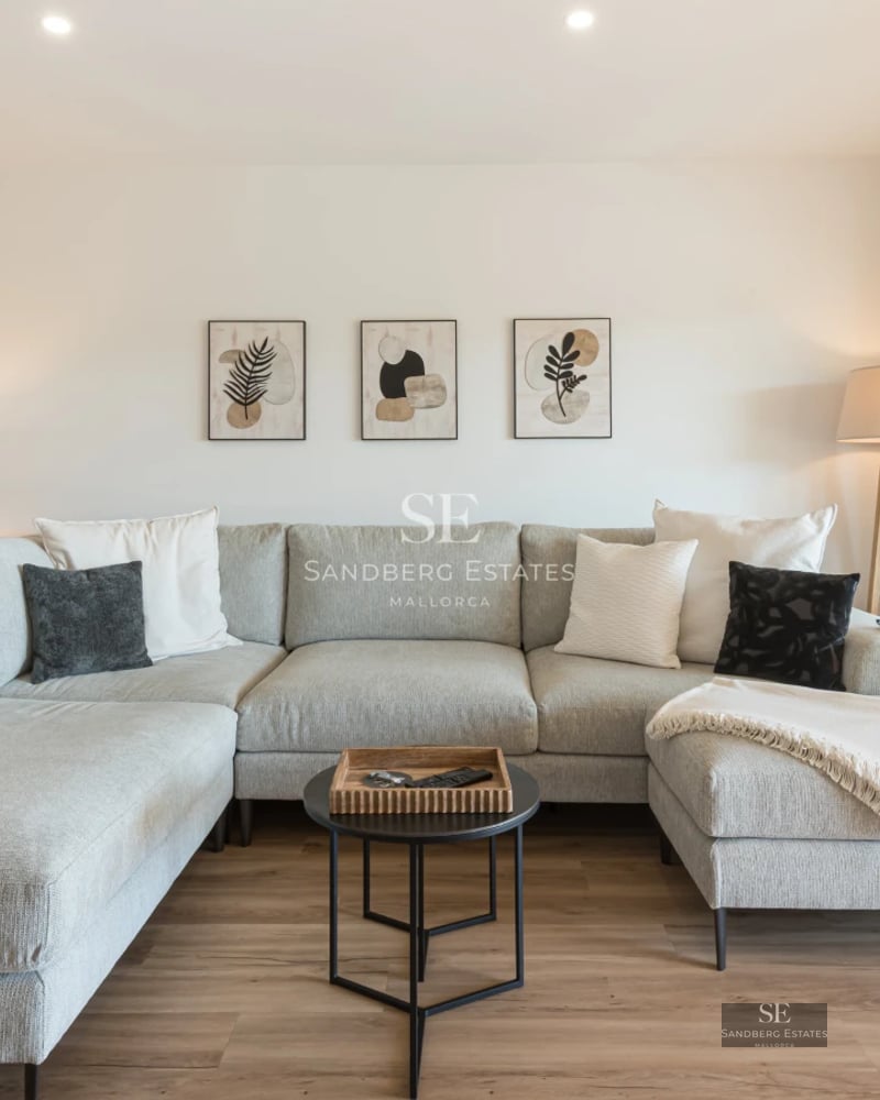 View of infinity pool surrounded by greenery and modern architecture with large windows and terrace. Luxury and outdoor design.