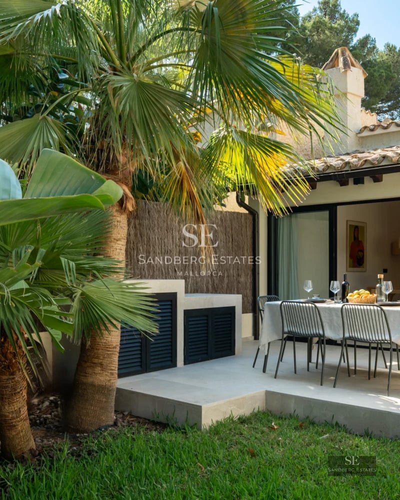 Spacious living room with large windows, light wood floors, and modern design. Abundant natural light and terrace access.