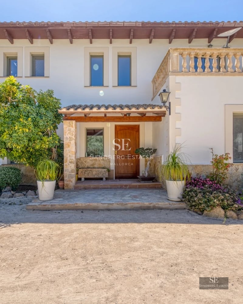 View of a modern villa featuring an infinity pool, lush garden, and spacious terraces. Minimalist architecture with panoramic windows.