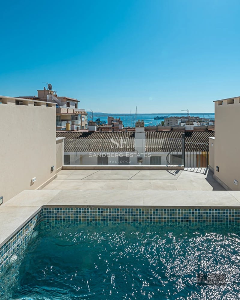 View of a luxurious villa with a pool, large windows, terrace, and garden. Modern architecture, elegant design.