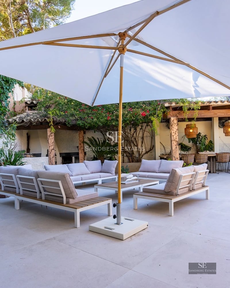 View of a luxurious villa with infinity pool, lush garden, and modern architecture. Elegant design and spacious areas.