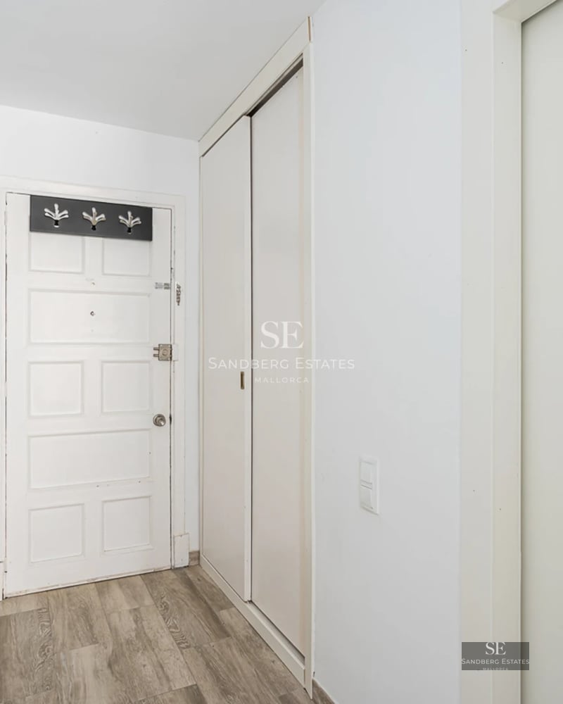 Spacious terrace featuring an infinity pool and panoramic sea views. Modern furniture, wooden floors, and glass railing.