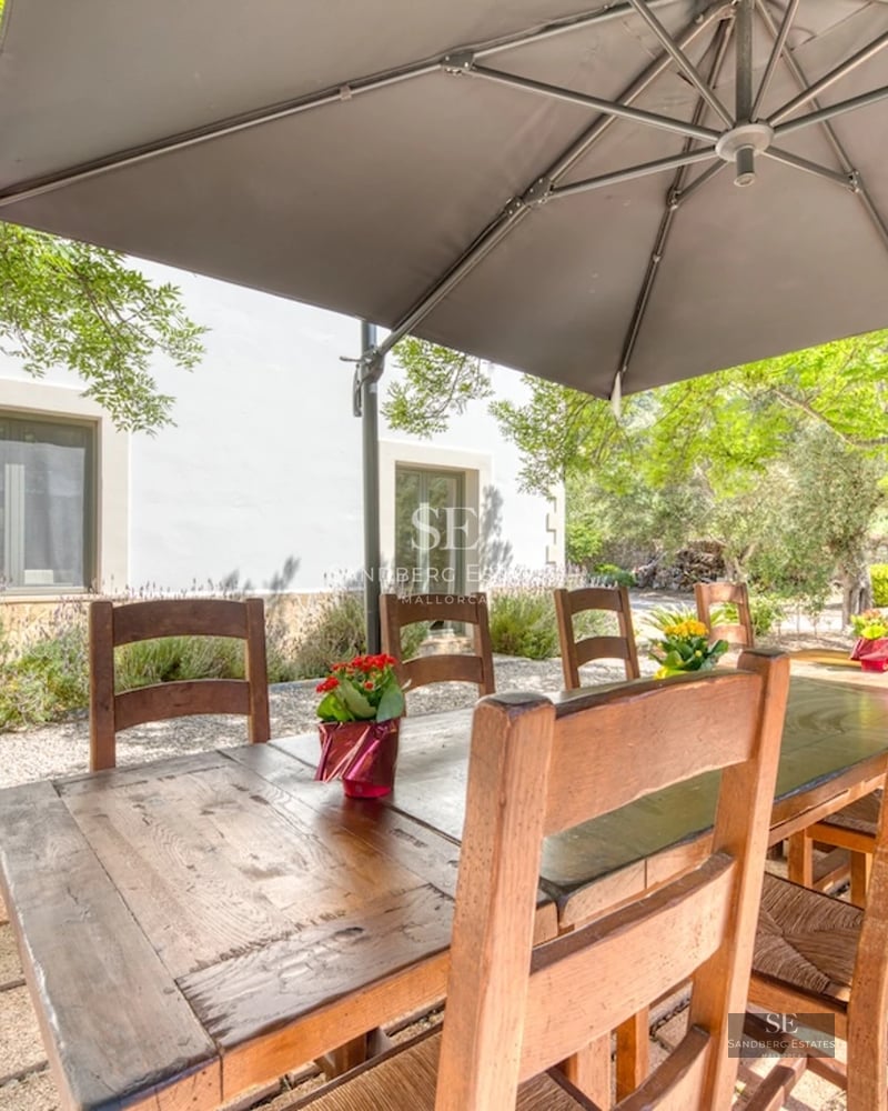 Expansive exterior with infinity pool, sun loungers, lush greenery, and modern architecture. A luxurious oasis.