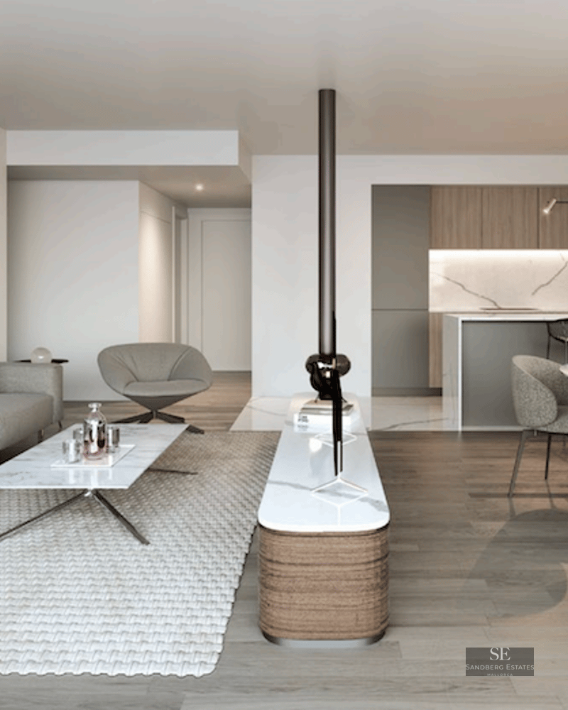 Modern open-plan living room with grey sofa, marble coffee table, and dining area with a view of a minimalist kitchen.