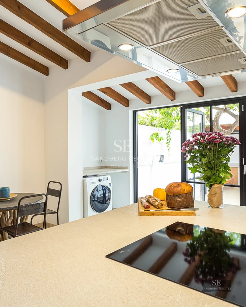 Panoramic sea view from spacious balcony. Modern design, glass railing, wood flooring, and elegant furniture. Lush vegetation.