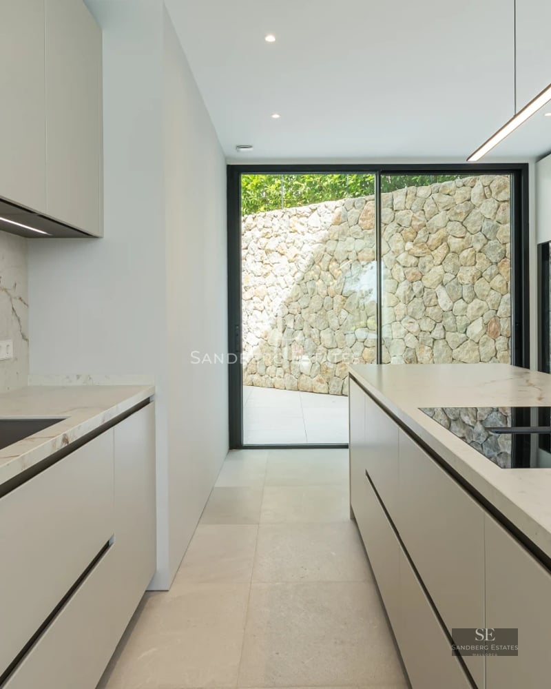 Spacious terrace with pool, sun loungers, and garden views. Modern, elegant, and bright architecture. Ideal for enjoying the outdoors.