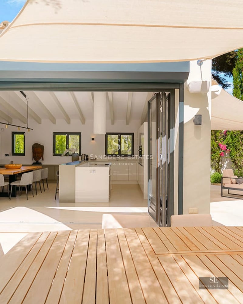Modern terrace featuring an infinity pool, lounge chairs, ocean views, and stylish furniture. Minimalist design with greenery.
