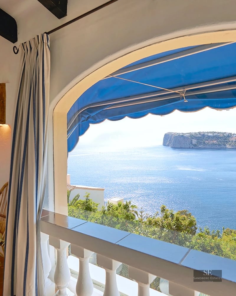 Exterior view of modern villa with reflecting pool, manicured lawn, and minimalist architecture. Large windows maximize natural light.