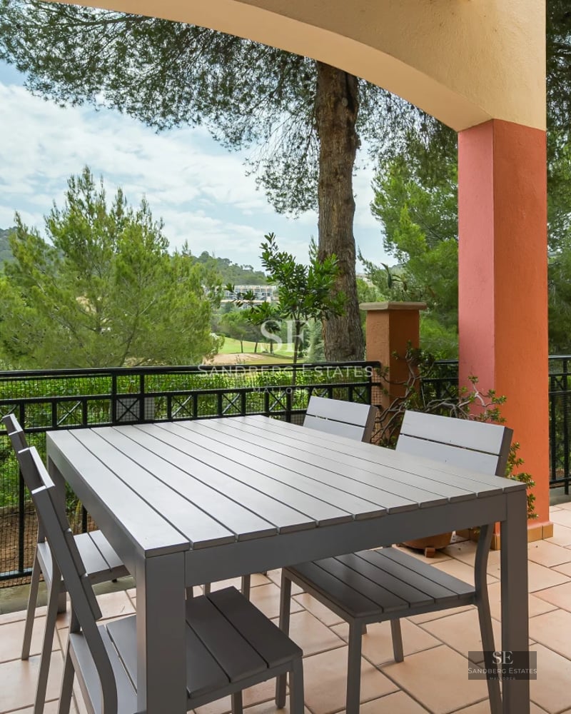 Exterior view of a modern villa with an infinity pool, lush garden, and spacious terraces offering panoramic sea views.