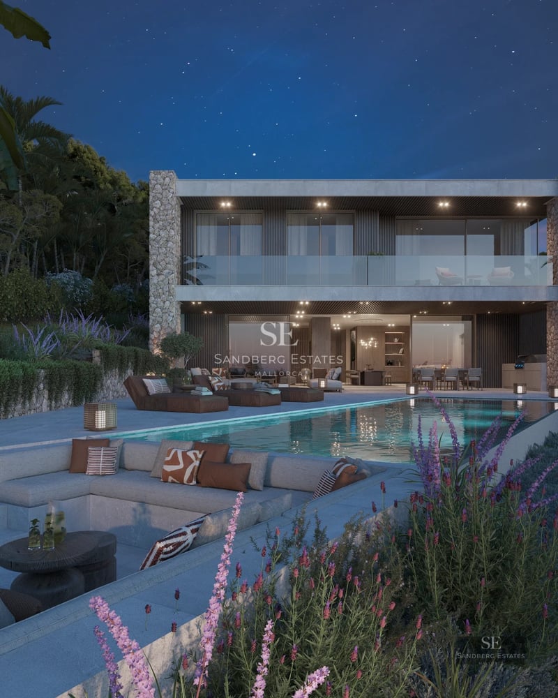 Spacious balcony with sea view. Modern grey and white furniture. Glass railing offers unobstructed views. Minimalist design.