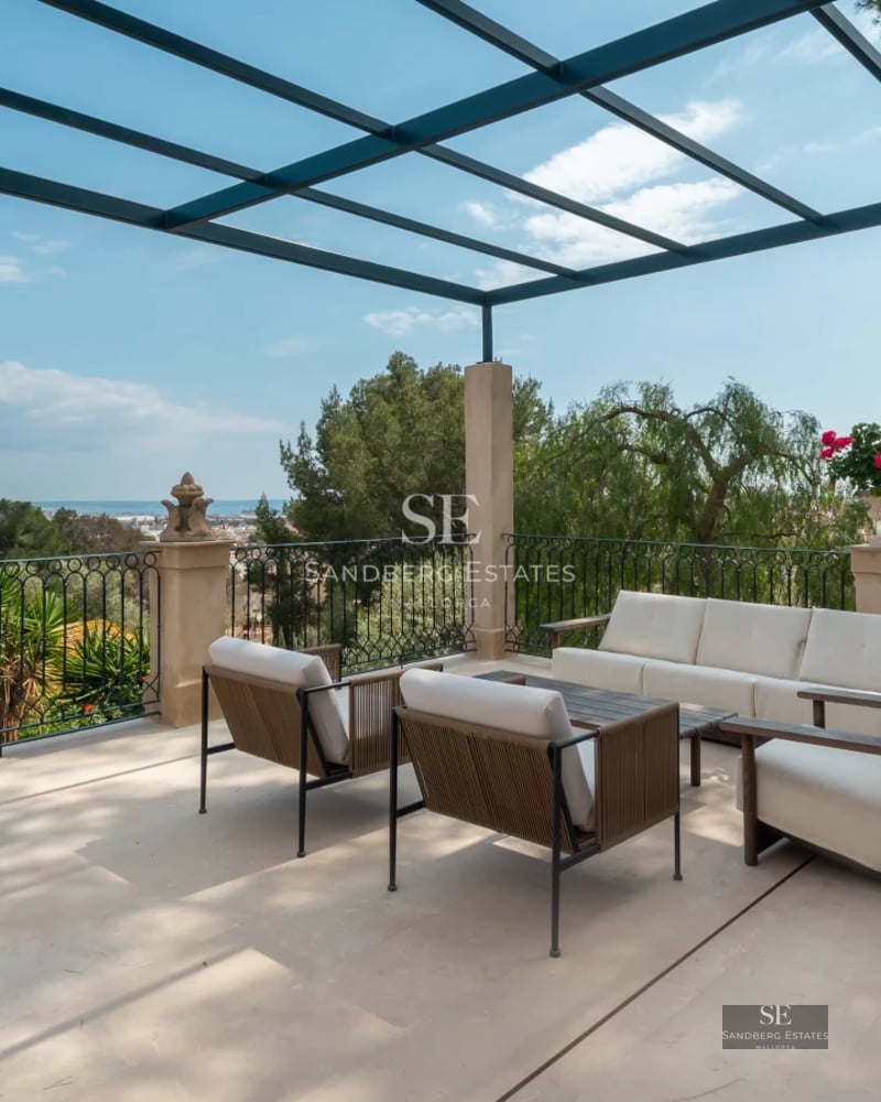 Exterior view of a modern villa featuring a pool, lush garden, and spacious terraces. Stylish design and high-quality finishes.