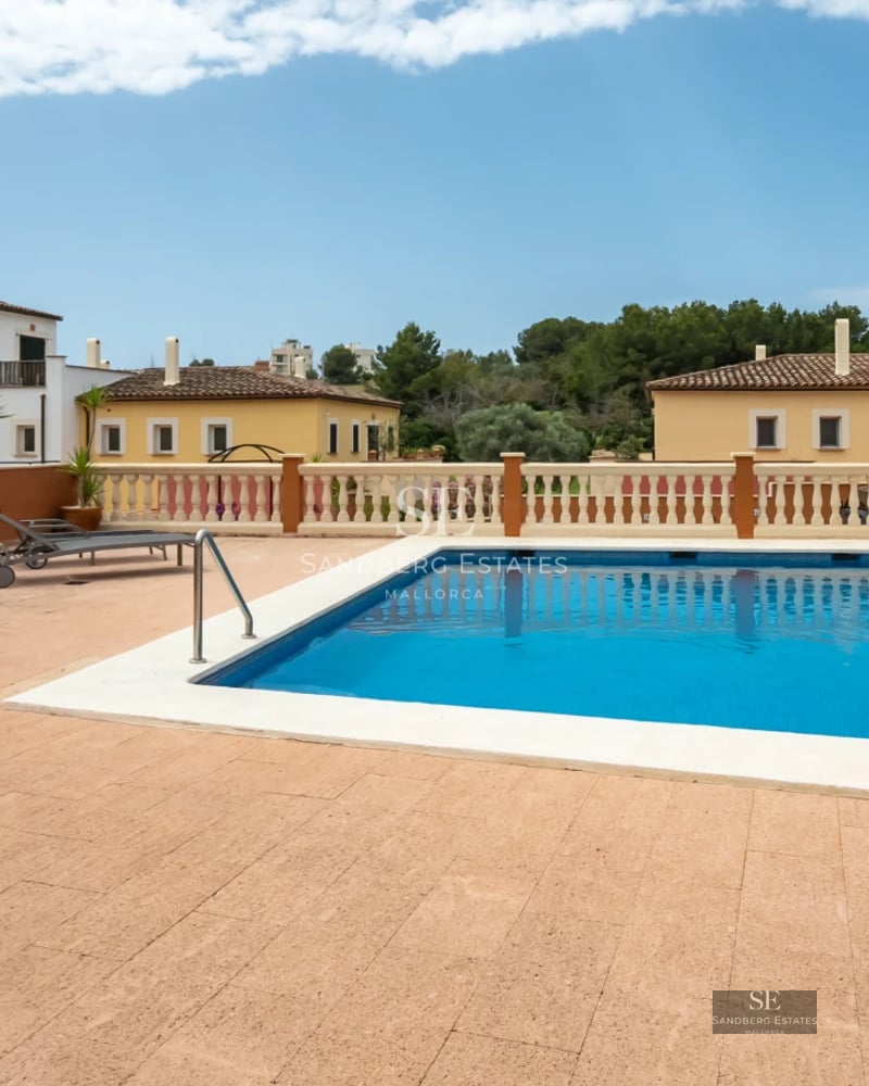 View of a modern villa with a pool, surrounded by greenery. Elegant architecture and contemporary design.