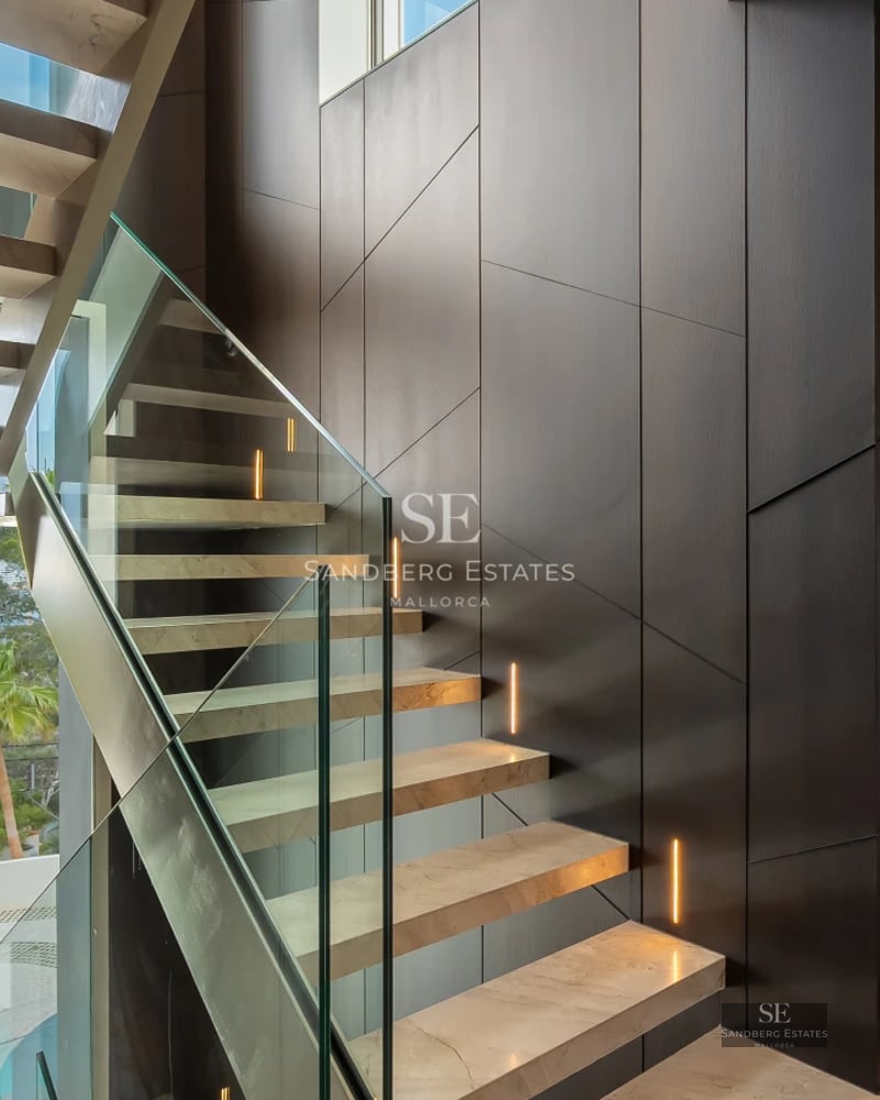 Exterior of a modern villa with infinity pool, lush garden, and spacious terraces. Minimalist architectural design and high-quality finishes.