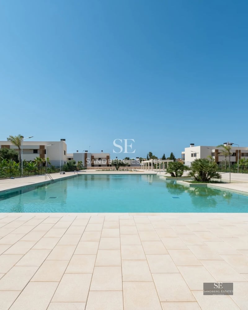 Spacious terrace with swimming pool, sun loungers, and panoramic views. Modern design with high-quality materials.