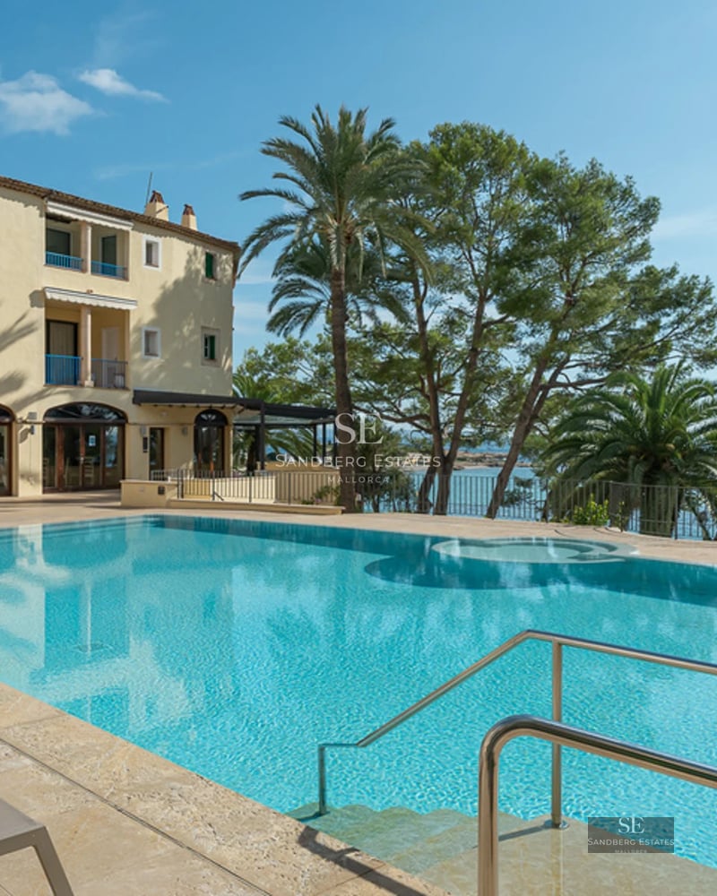 Aerial view of modern villa with pool, garden, and terrace. Minimalist architecture, large windows, and ambient lighting.