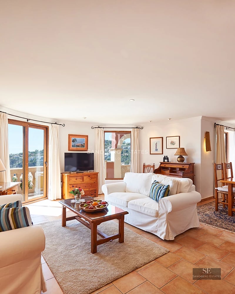 Spacious garden with pool, sun loungers, and seating area. Modern architecture with large windows and lush vegetation.