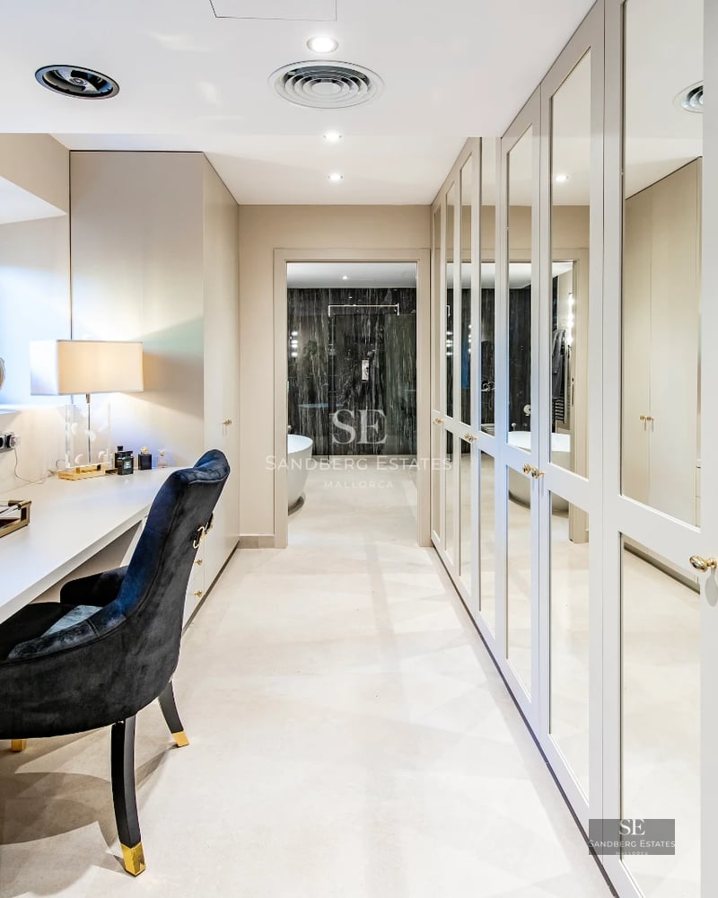 Spacious terrace with infinity pool, sun loungers, and panoramic sea views. Modern, elegant design with lush greenery.