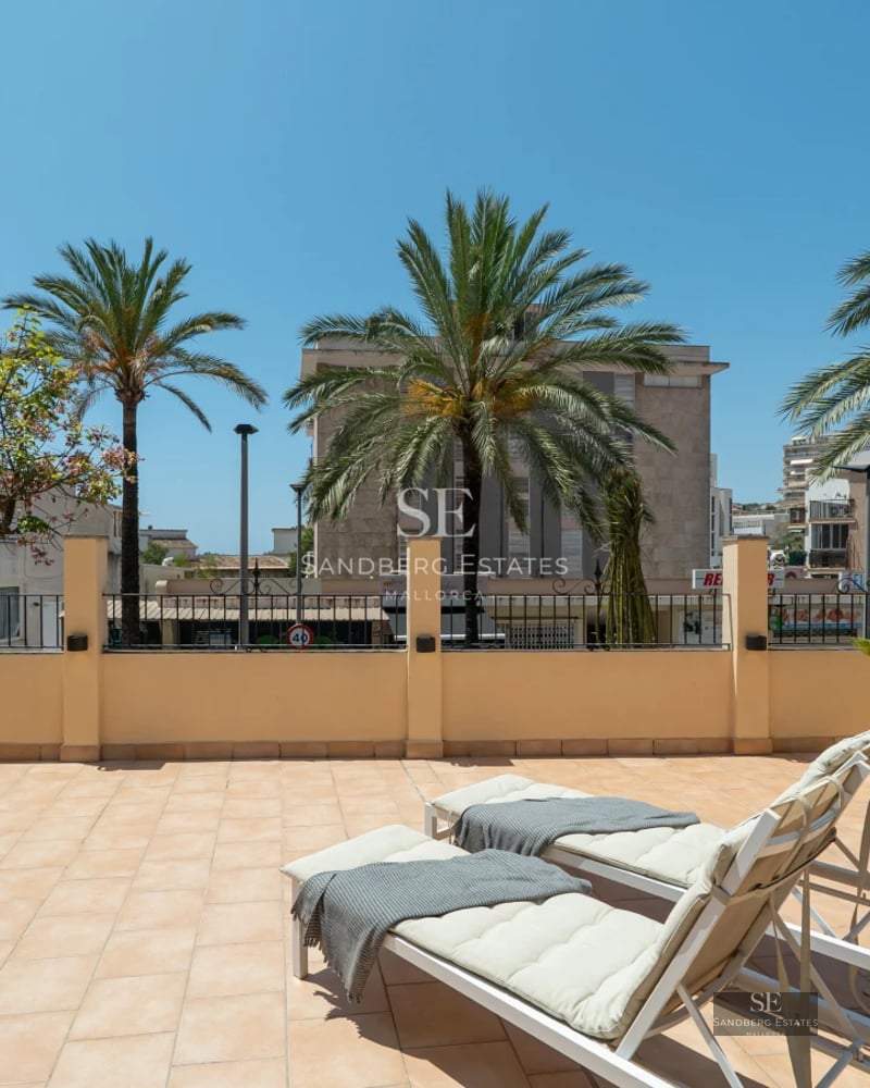 View of a modern villa with swimming pool. Large windows, sun terrace and lush vegetation. Contemporary architectural design.
