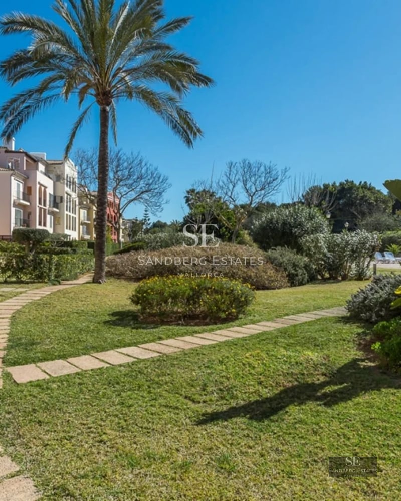 Exterior view of a modern villa featuring a pool, expansive terraces, lush greenery, and minimalist architecture. White facade and large windows.