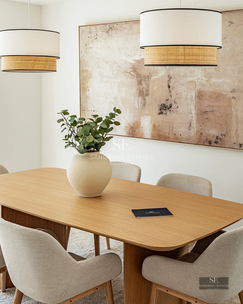 Exterior view of a modern villa featuring a pool, garden, and large windows providing ample natural light.