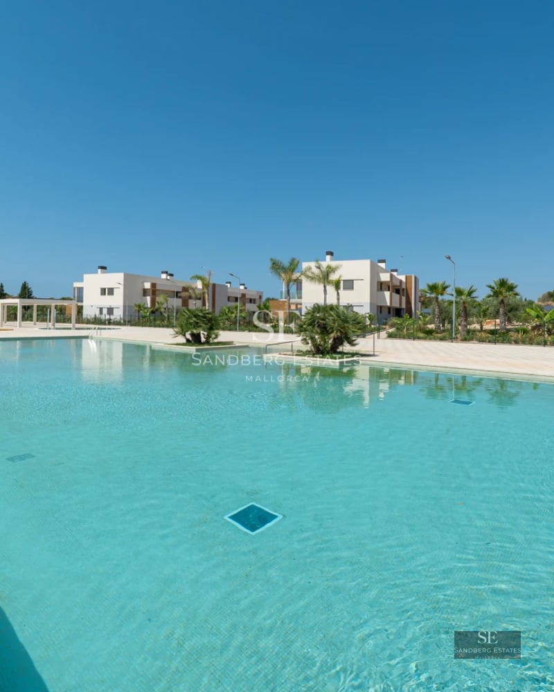 Spacious terrace with infinity pool, lounge chairs, and panoramic views. Modern design with soft ambient lighting and lush vegetation.