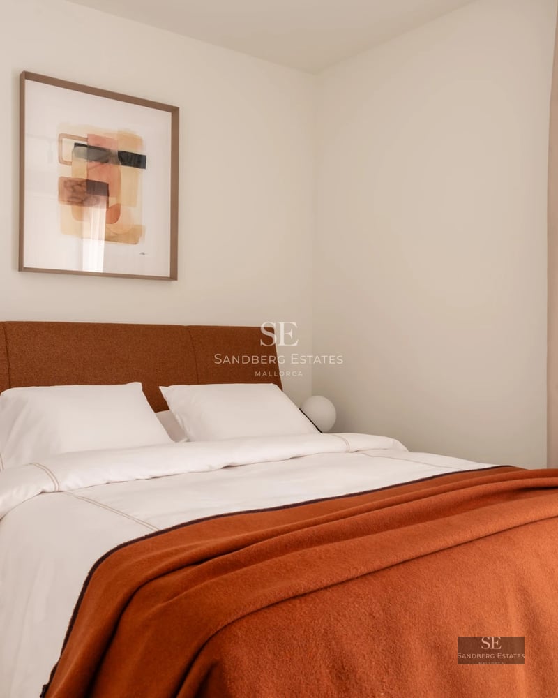 View of infinity pool with vanishing edge, manicured lawn, trees, and modern minimalist-design house in the background.