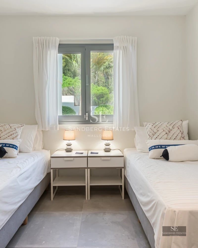 Exterior of modern villa featuring a shimmering pool, large windows, and lush landscaping. Soft ambient lighting.