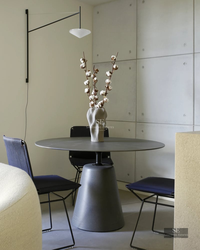 Bright living room featuring large windows, an infinity pool, and panoramic views. Modern design with hardwood floors and elegant furniture.