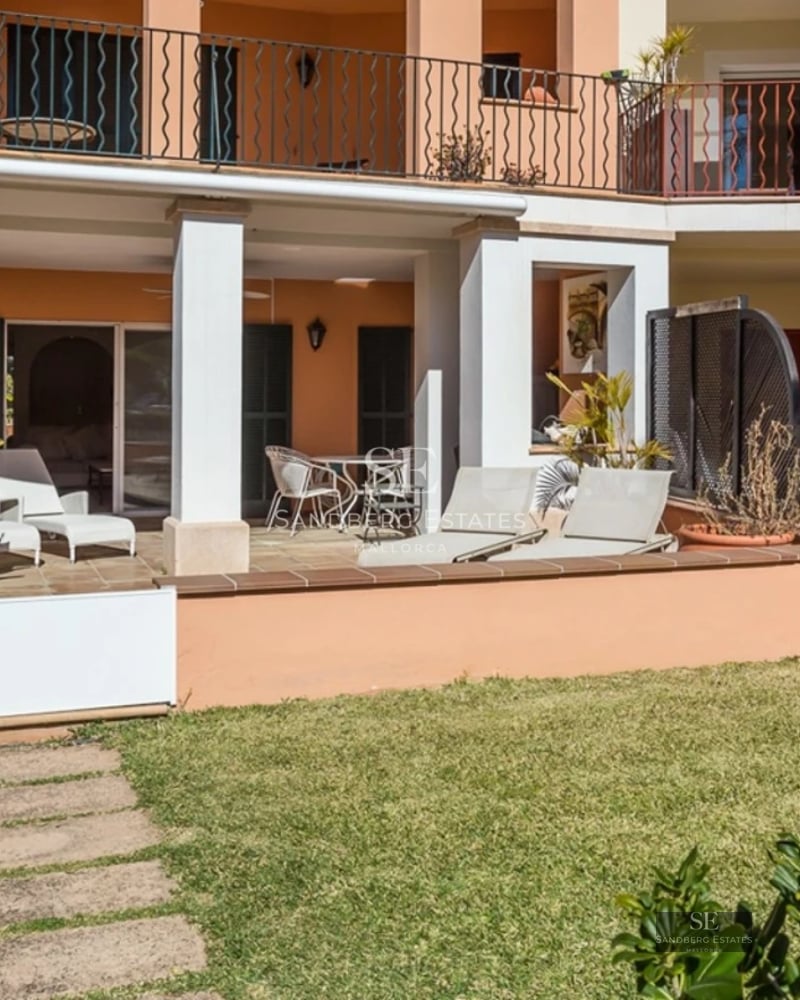 Bright living room with infinity pool, large windows, light wood floors, and modern furniture. Panoramic views.