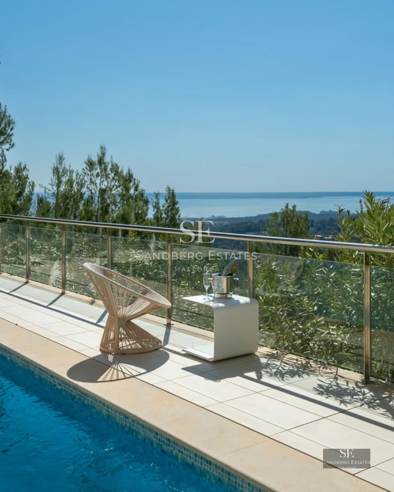 Expansive terrace with infinity pool, sun loungers, and panoramic sea views. Modern design with clean and elegant lines.