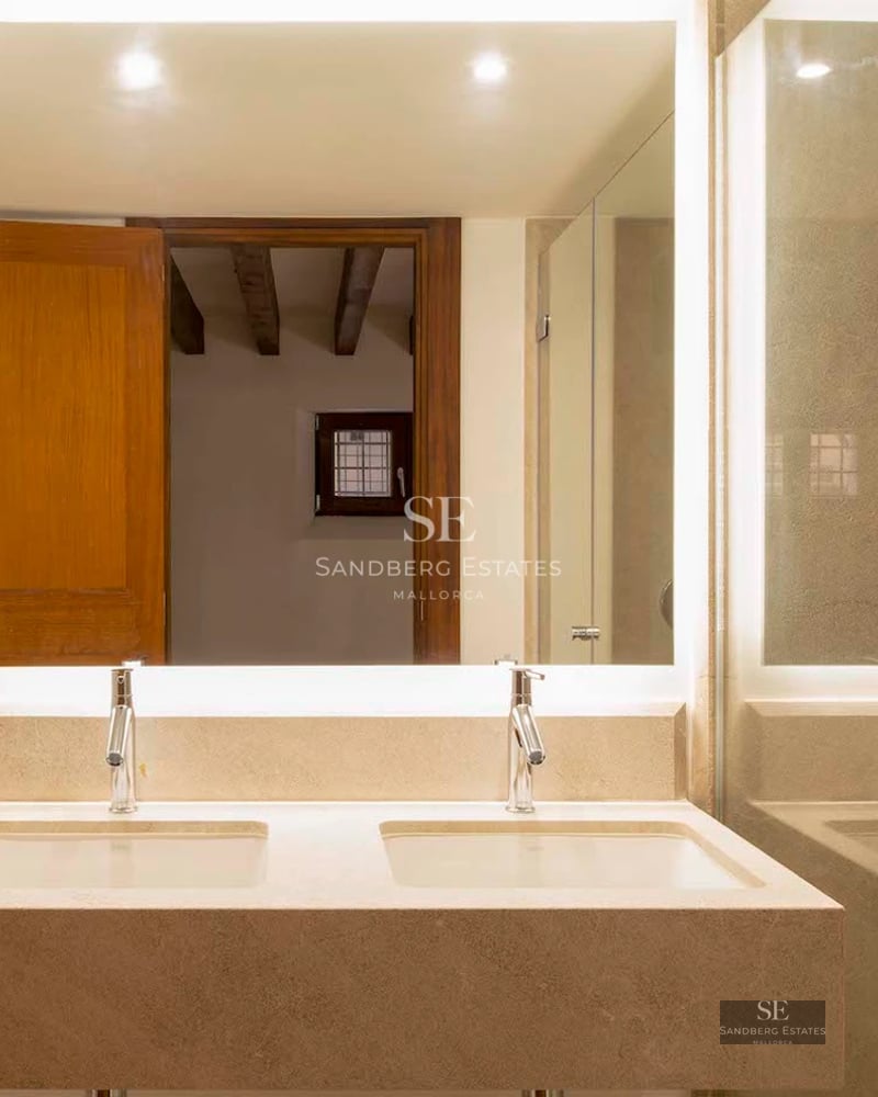 Spacious terrace with infinity pool, ocean views, modern furniture, and lush vegetation. Soft lighting and relaxing ambiance.