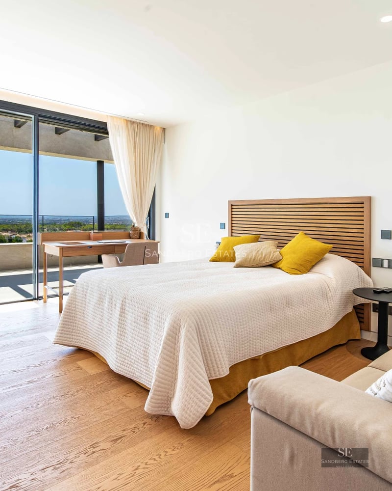 Expansive terrace featuring an infinity pool and panoramic views. Modern architecture with glass railings and elegant furniture.