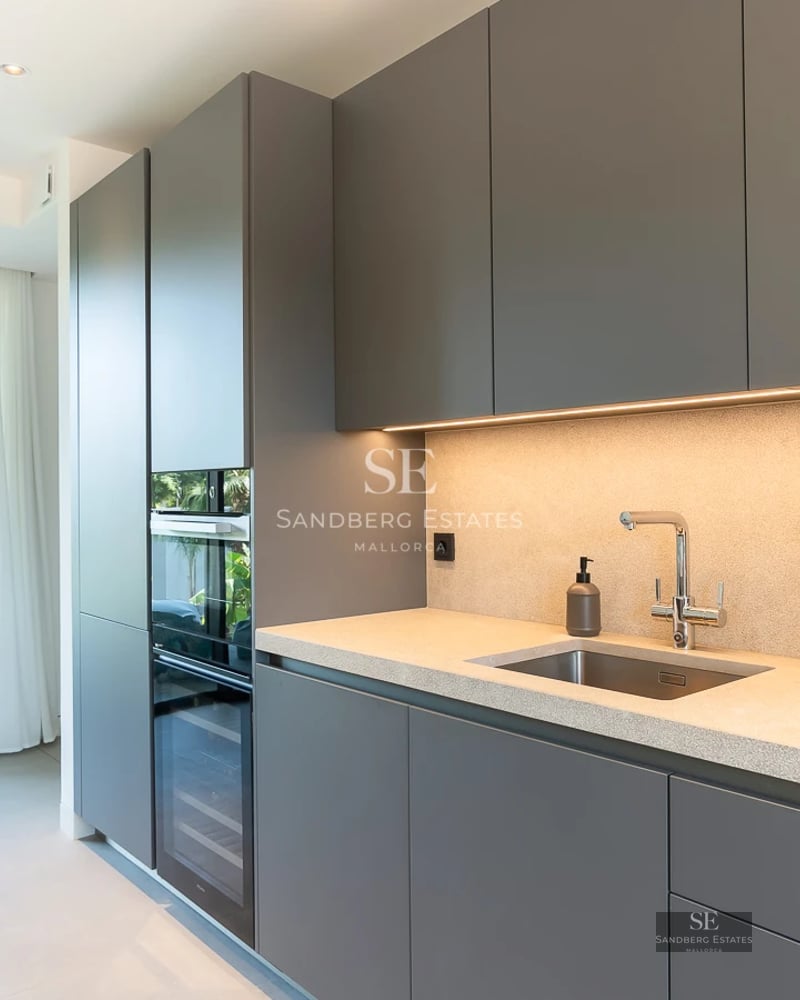 View of infinity pool with modern design, surrounded by gardens and panoramic sea views. Spacious terraces and minimalist architecture.