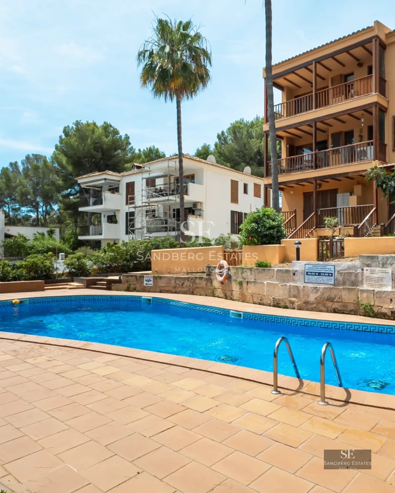 Exterior view of a modern villa featuring an infinity pool, spacious terraces, and lush gardens. Minimalist architecture and landscaping.