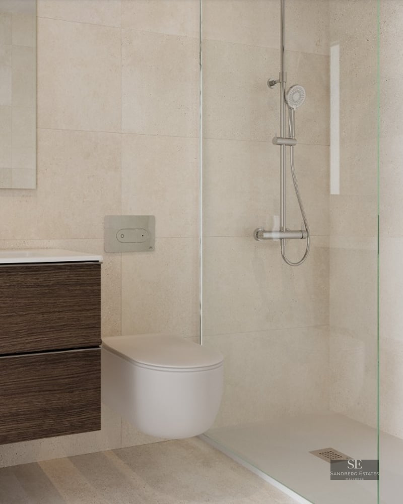 Modern bathroom featuring a dark wood floating vanity, wall-mounted toilet, and glass-enclosed walk-in shower with beige tiles.
