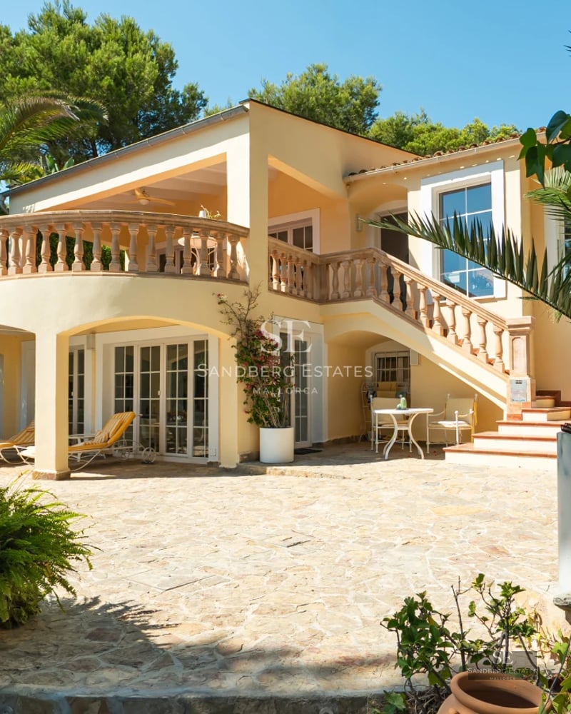Image of a villa with infinity pool. Modern architecture, large terraces, lush garden, and panoramic views.