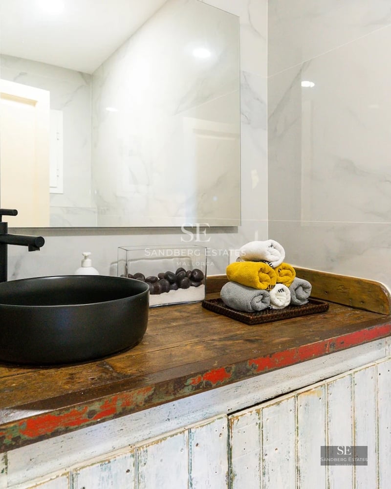 Exterior view of a modern villa featuring an infinity pool, large garden, and minimalist architecture. White facade and large window fronts.