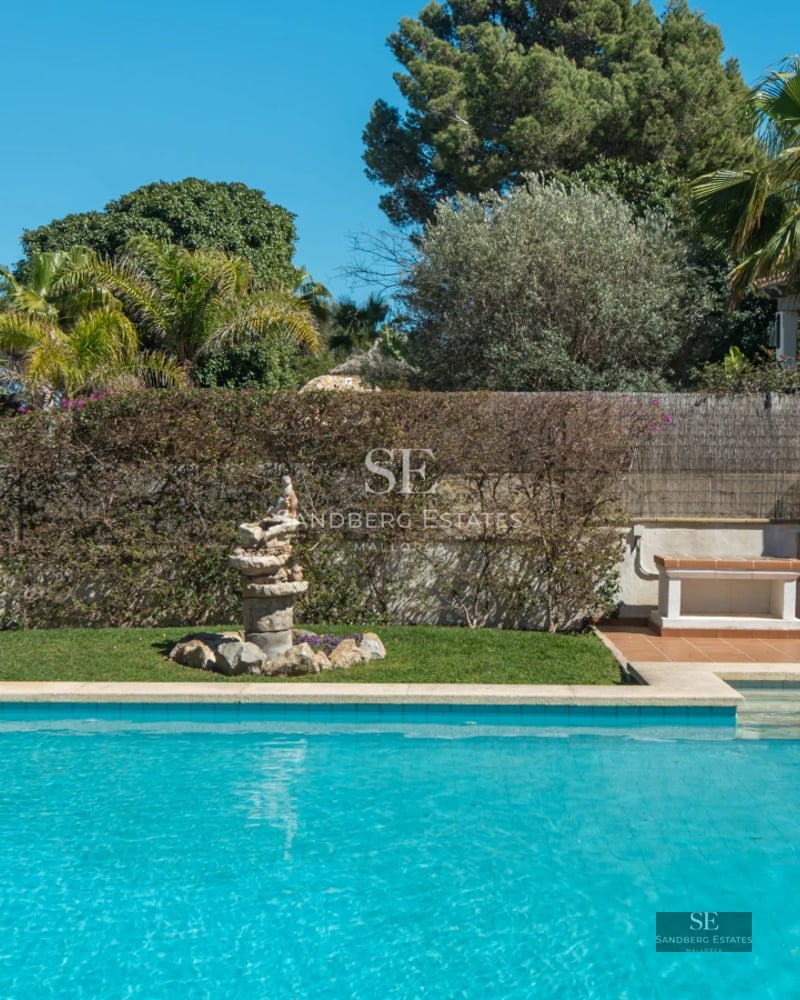 Large balcony with sea view. Modern design, glass railing, wooden floor. Soft lighting and elegant furniture.