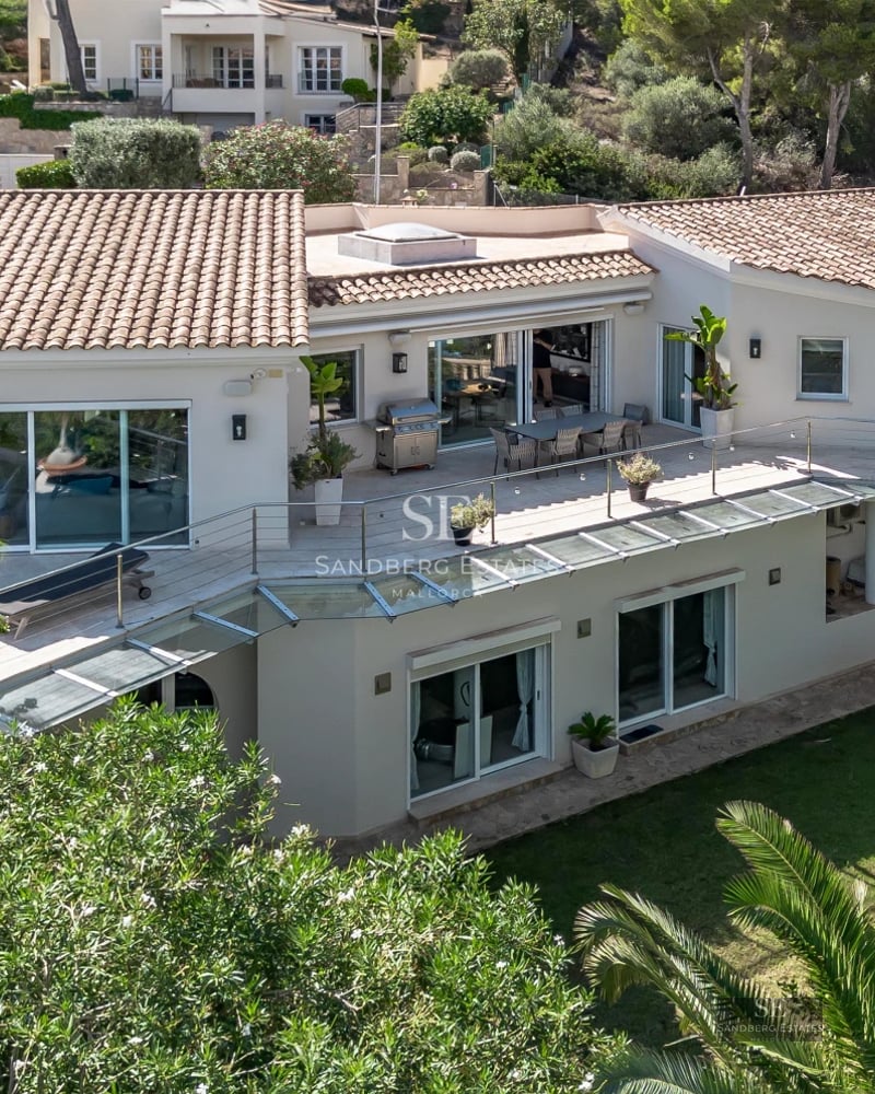 Spacious living room with picture windows, modern fireplace, designer furniture, and spectacular sea views. Natural light and high-quality finishes.
