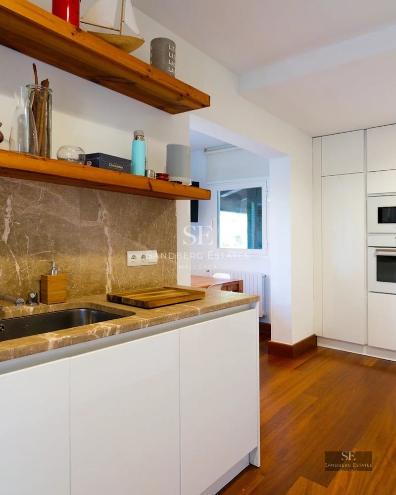 Exterior view of a modern villa with infinity pool, surrounded by greenery. Minimalist architecture with large glass windows and terrace.