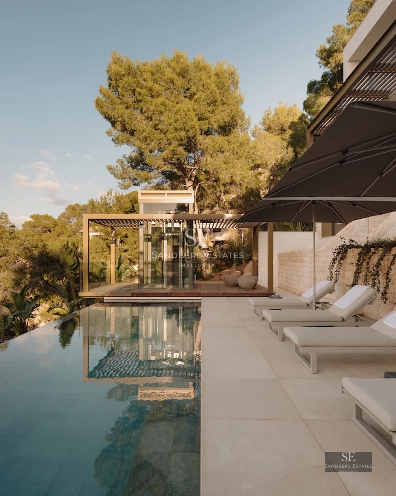 Minimalist exterior featuring infinity pool, spacious terraces, lush greenery, and panoramic ocean views. Contemporary, elegant design.