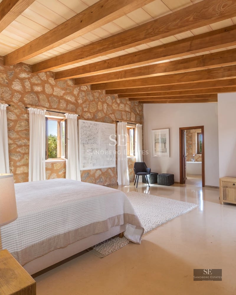 Modern living room with large windows, sea view, and stylish furniture. Light wood floors and private terrace.