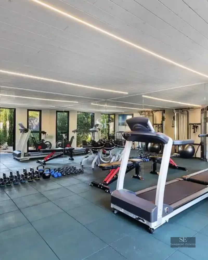 Spacious living room with panoramic sea views, modern sofas, textured rug, and soft ambient lighting.