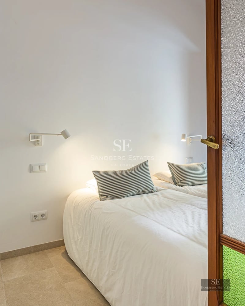 Modern apartment with glass-enclosed balcony offering panoramic sea views. Sleek design with natural light and high-quality furnishings.