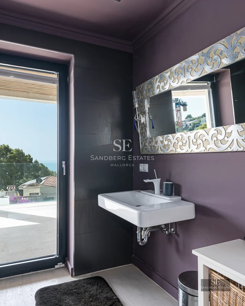 Modern facade with reflecting pool. Minimalist design, large windows, and landscaped area. Contemporary architecture.