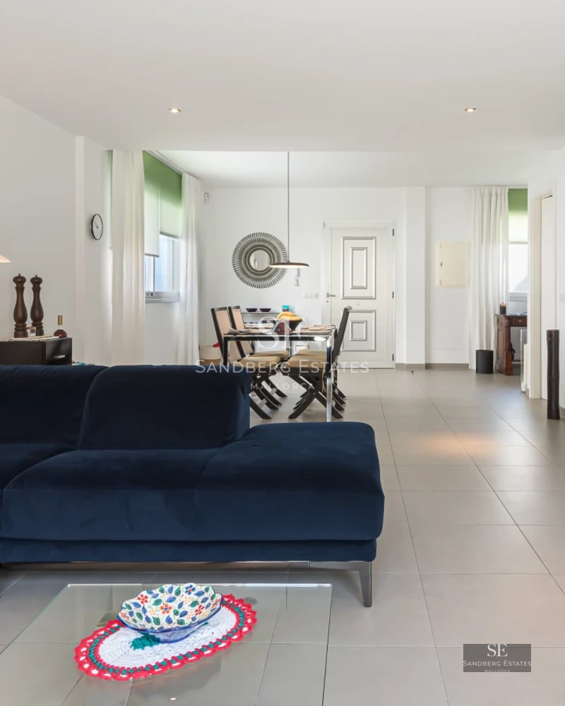 Expansive living room with large windows, pool, and garden. Modern design, natural light, and high-quality finishes.