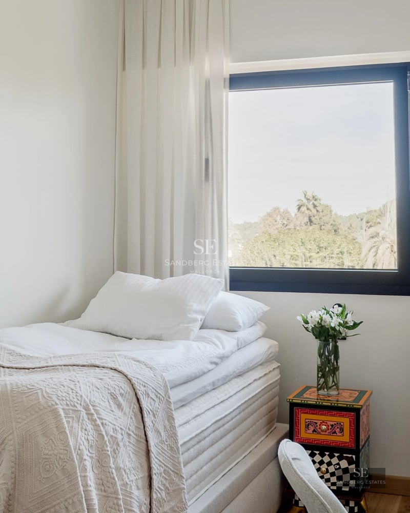 Exterior view of a modern villa with a pool, surrounded by greenery. Minimalist architectural design and large open spaces.