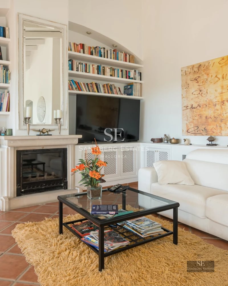 Exterior view of a modern villa with an infinity pool, lush garden, and large windows. Minimalist architecture, elegant design, and manicured landscaping.